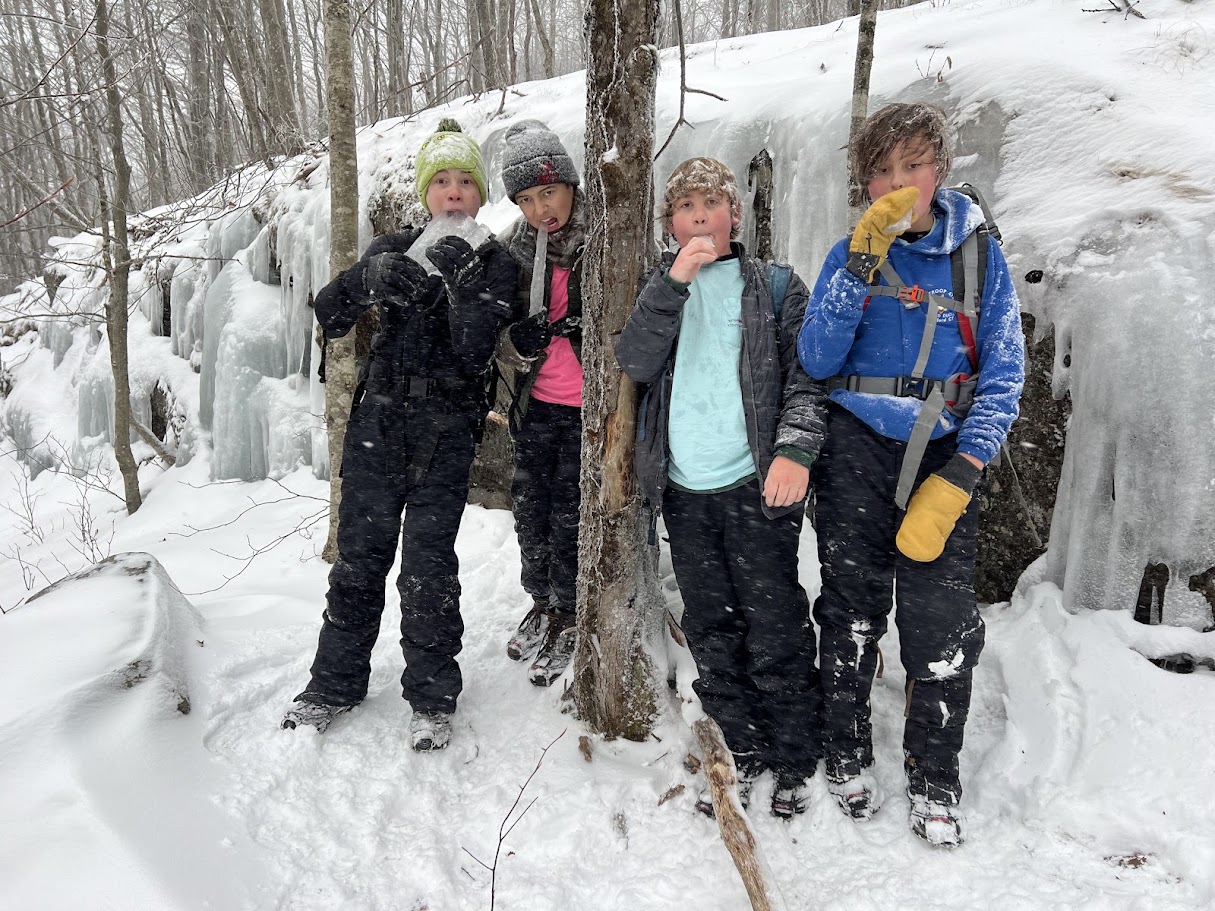 Scouts standing near a frozen waterfall during the Mount Monadnock trip.